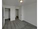 Carpeted bedroom featuring closet and door at 12892 E 99Th Pl, Commerce City, CO 80022