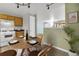 Cozy dining area with a round wooden table, seating for four, and a plant at 9360 Lowell Blvd, Westminster, CO 80031