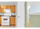 View of the kitchen, featuring wood cabinets, white appliances, and modern touches at 9360 Lowell Blvd, Westminster, CO 80031