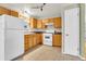 Functional kitchen with wood cabinets, tile flooring, and white appliances at 9360 Lowell Blvd, Westminster, CO 80031