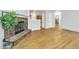 Open-concept living space with hardwood floors and a fireplace, leading to the kitchen at 9360 Lowell Blvd, Westminster, CO 80031