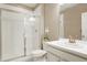 Bright bathroom with a glass door shower, white vanity, and ample lighting makes a stylish statement at 13034 Bridge View Ln, Parker, CO 80134