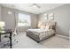 Cozy bedroom featuring a comfortable bed, a large window, and a desk with chair for studying at 13034 Bridge View Ln, Parker, CO 80134