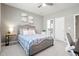 Comfortable bedroom with a bed, a ceiling fan, and an ensuite bathroom for added privacy and convenience at 13034 Bridge View Ln, Parker, CO 80134