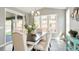 Elegant dining room featuring a chandelier, large windows, and a sliding glass door to the outdoor area at 13034 Bridge View Ln, Parker, CO 80134