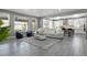 Open concept living area with hardwood floors, bright windows, and access to the kitchen and dining area at 13034 Bridge View Ln, Parker, CO 80134