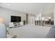 Open loft area with TV, seating and a stairway at 13034 Bridge View Ln, Parker, CO 80134