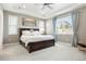 Spacious main bedroom featuring a ceiling fan, large windows, and a comfortable bed with storage drawers at 13034 Bridge View Ln, Parker, CO 80134