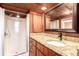Stylish bathroom with wood paneling, granite countertop, modern fixtures, and a walk-in shower at 85 Revett Dr # 66, Breckenridge, CO 80424