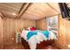 Comfortable bedroom boasting wood walls, recessed lighting, and closet space at 85 Revett Dr # 66, Breckenridge, CO 80424