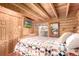 Comfortable bedroom with wood paneling, a quilt-covered bed, and a mounted television at 85 Revett Dr # 66, Breckenridge, CO 80424