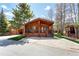 Cozy log cabin-style house featuring a covered porch, natural landscaping, and a peaceful atmosphere at 85 Revett Dr # 66, Breckenridge, CO 80424