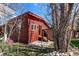 Rear exterior view of a house with wood walls plus a small shed and rocky landscaping at 85 Revett Dr # 66, Breckenridge, CO 80424