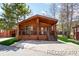 Charming cabin-style home featuring a covered porch and wooden accents in a serene, natural setting at 85 Revett Dr # 66, Breckenridge, CO 80424