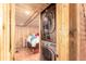 A functional laundry room with a stackable washer and dryer and wood paneling at 85 Revett Dr # 66, Breckenridge, CO 80424