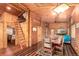 Charming rustic living room with wood paneling, wooden floors, and a dining area perfect for Gathering gatherings at 85 Revett Dr # 66, Breckenridge, CO 80424