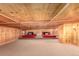 Unique loft area with wood paneling, carpeted floors, and red lounge beds at 85 Revett Dr # 66, Breckenridge, CO 80424