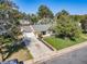 Charming single-story home featuring an attached garage, manicured lawn, and mature trees at 9927 E 7Th Ave, Aurora, CO 80010