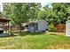 Backyard with green lawn and detached small garage or shed at 1215 S Ivanhoe Way, Denver, CO 80224