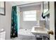 Bright bathroom with a shower-tub combination and a single sink vanity at 1215 S Ivanhoe Way, Denver, CO 80224