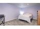 Cozy bedroom with neutral carpet, simple furnishings, and plenty of natural light at 1215 S Ivanhoe Way, Denver, CO 80224