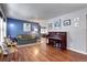 Spacious living room with hardwood floors, comfortable seating, and a decorative piano at 1215 S Ivanhoe Way, Denver, CO 80224