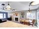 Comfortable living space featuring a fireplace, a dining area, and ample natural light at 1215 S Ivanhoe Way, Denver, CO 80224
