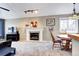 Inviting living space featuring a fireplace, a dining area, and a well-lit room at 1215 S Ivanhoe Way, Denver, CO 80224