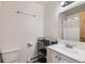 Clean bathroom with a white vanity, updated sink, and storage shelving at 695 Manhattan Dr # 109, Boulder, CO 80303