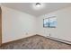 Bright bedroom with neutral paint, new carpet, baseboard heat, and a window at 695 Manhattan Dr # 109, Boulder, CO 80303