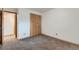 Neutral bedroom featuring carpeted floors, base trim, and light wood closet doors at 695 Manhattan Dr # 109, Boulder, CO 80303