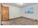Cozy bedroom with neutral paint, new carpet, baseboard heat, and a window at 695 Manhattan Dr # 109, Boulder, CO 80303