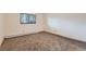 Bright bedroom featuring neutral carpeting and a large window at 695 Manhattan Dr # 109, Boulder, CO 80303