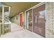 Patio exterior with slider and red door at unit, and walkway access at 695 Manhattan Dr # 109, Boulder, CO 80303