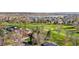 Lush scenery surrounds a single story home near a sprawling golf course, offering serene neighborhood views at 16 Wedge Way, Littleton, CO 80123