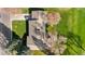 Birds eye view of a home featuring well manicured lawns, driveway with car and mature landscaping at 16 Wedge Way, Littleton, CO 80123