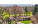 Striking aerial view of a well-maintained single story home with lush green lawn backing up to a manicured golf course at 16 Wedge Way, Littleton, CO 80123