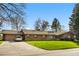 Charming single-story brick home boasting a tile roof, attached garage, and a beautifully manicured front lawn at 16 Wedge Way, Littleton, CO 80123