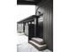 Black door with glass panes, steps leading to the door and snow on the ground at 860 S Quivas St, Denver, CO 80223