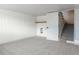 Basement with carpeted floor, storage shelving and stairs to upper level at 860 S Quivas St, Denver, CO 80223