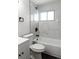 Updated bathroom with marble tile shower/tub combo at 860 S Quivas St, Denver, CO 80223