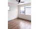 Light-filled bedroom with hardwood floors and ceiling fan at 860 S Quivas St, Denver, CO 80223