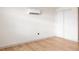 Bright bedroom with light wood floors, and a wall mounted AC unit at 860 S Quivas St, Denver, CO 80223