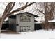 Gray house with black accents, covered carport, and snowy yard at 860 S Quivas St, Denver, CO 80223