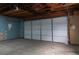 Empty garage with white door and concrete floor at 860 S Quivas St, Denver, CO 80223