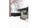 Gray house exterior with black fence and snowy yard at 860 S Quivas St, Denver, CO 80223