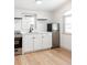 Modern white kitchen with stainless steel appliances at 860 S Quivas St, Denver, CO 80223