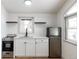 Modern white kitchen with stainless steel appliances at 860 S Quivas St, Denver, CO 80223