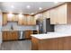 Modern kitchen with light wood cabinets, white countertops, and stainless steel appliances at 860 S Quivas St, Denver, CO 80223