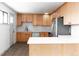 Modern kitchen with light wood cabinets, white countertops, and stainless steel appliances at 860 S Quivas St, Denver, CO 80223